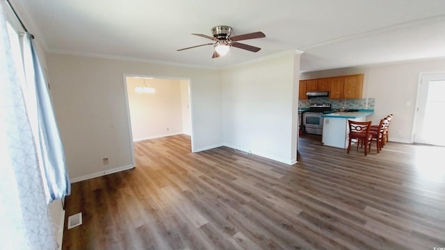 unfurnished living room with light hardwood / wood-style floors, crown molding, and plenty of natural light