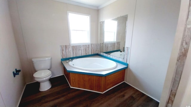 bathroom with toilet, wood-type flooring, and ornamental molding