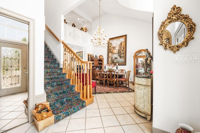 entryway with high vaulted ceiling, tile patterned floors, and a chandelier