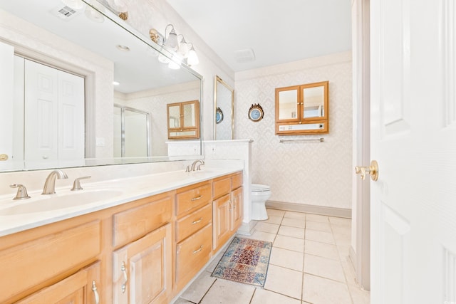 bathroom with vanity, tile patterned floors, toilet, and walk in shower