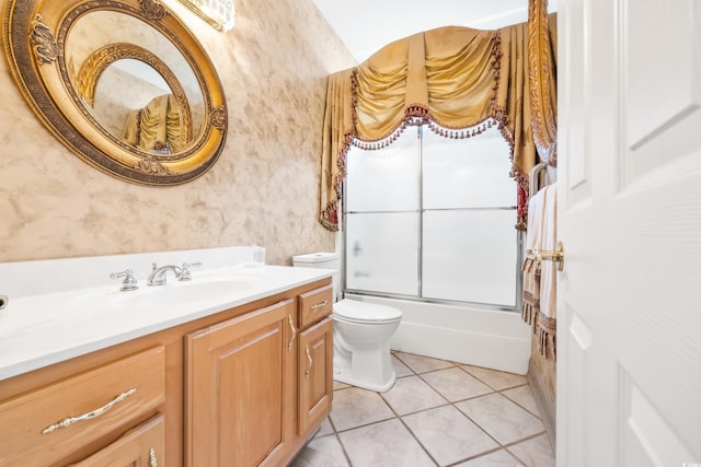 full bathroom featuring tile patterned flooring, vanity, combined bath / shower with glass door, and toilet