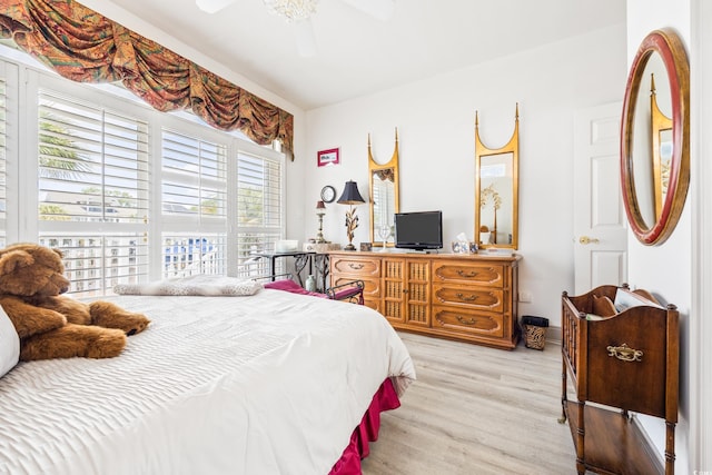 bedroom with ceiling fan and light hardwood / wood-style flooring