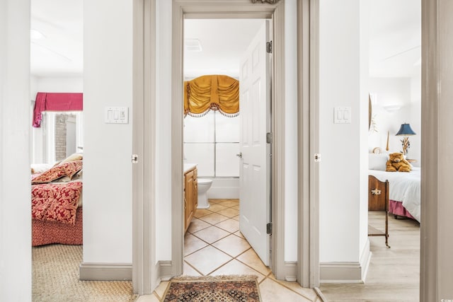 hall with light tile patterned floors