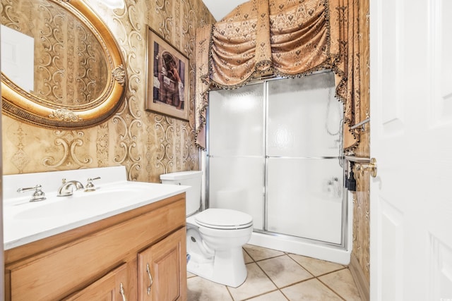 bathroom with an enclosed shower, vanity, tile patterned floors, and toilet