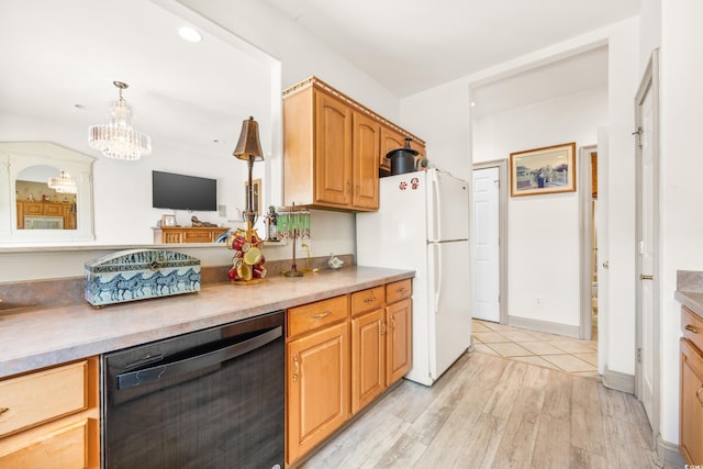 kitchen with decorative light fixtures, black dishwasher, white fridge, an inviting chandelier, and light hardwood / wood-style flooring