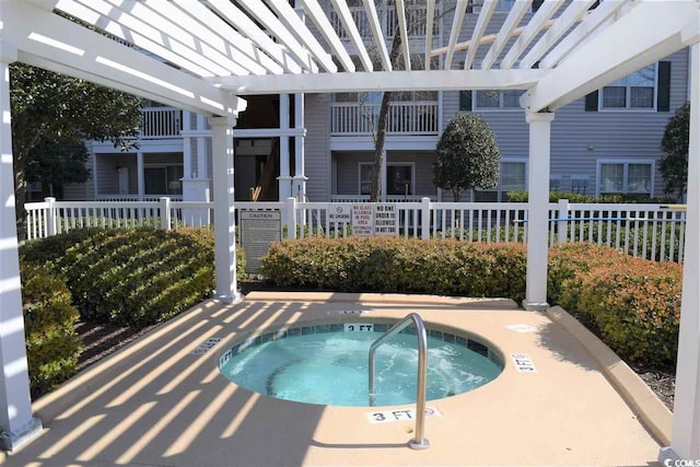 view of swimming pool with a pergola and a hot tub