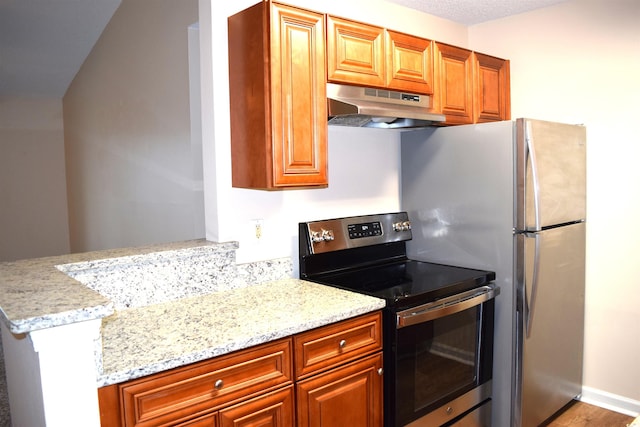 kitchen with light stone countertops, kitchen peninsula, extractor fan, a textured ceiling, and stainless steel range with electric cooktop