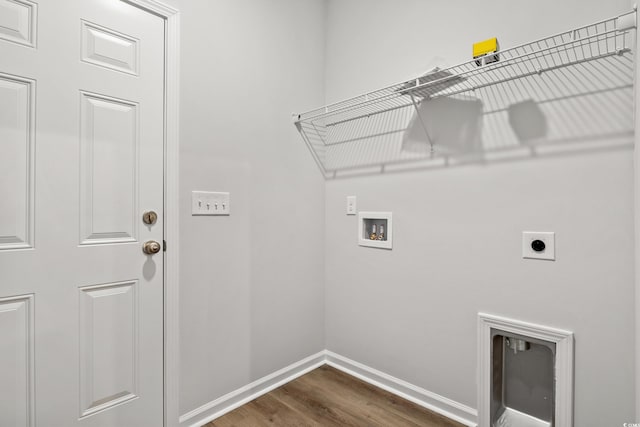 washroom featuring dark hardwood / wood-style floors, hookup for an electric dryer, and hookup for a washing machine