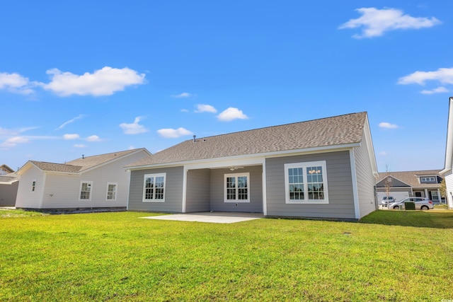 rear view of house with a patio area and a lawn