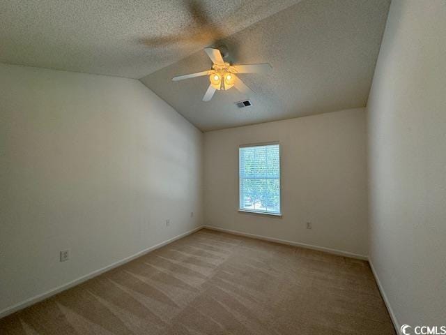 unfurnished room with a textured ceiling, ceiling fan, light colored carpet, and lofted ceiling