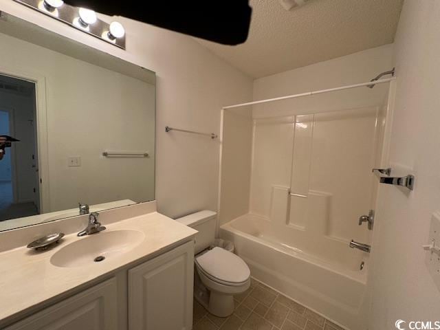 full bathroom featuring shower / bathing tub combination, vanity, toilet, and a textured ceiling