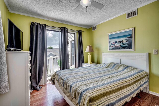 bedroom featuring access to exterior, ceiling fan, hardwood / wood-style floors, and a textured ceiling