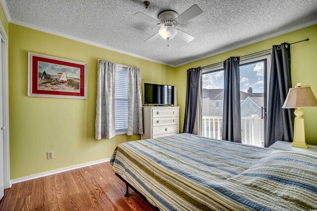 bedroom with ceiling fan, crown molding, a textured ceiling, and hardwood / wood-style flooring