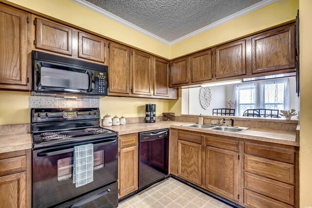 kitchen featuring crown molding, sink, black appliances, and a textured ceiling