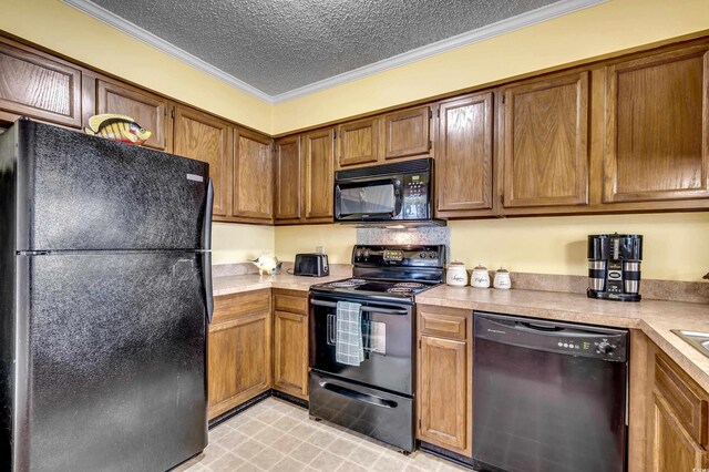 kitchen featuring black appliances, crown molding, and a textured ceiling