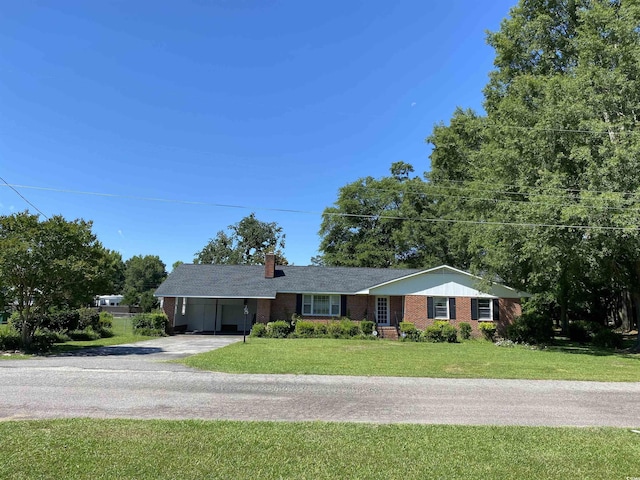 ranch-style house featuring a front yard and a carport