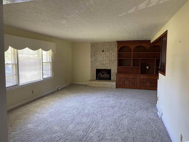 4155 Pinewood Dr, Mullins, SC 29574 - unfurnished living room with carpet floors, a textured ceiling, and a brick fireplace