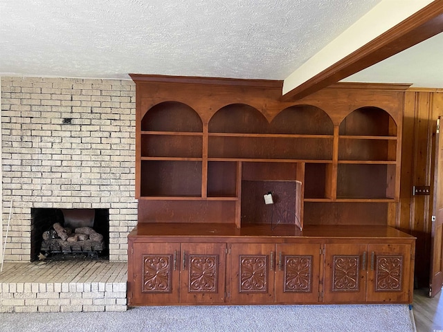 4155 Pinewood Dr, Mullins, SC 29574 - interior details with carpet, built in shelves, beamed ceiling, and a brick fireplace