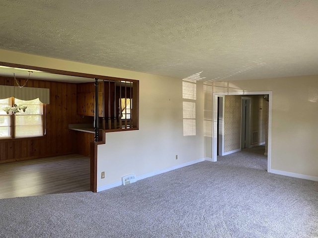 4155 Pinewood Dr, Mullins, SC 29574 - unfurnished room with wooden walls, carpet, and a textured ceiling