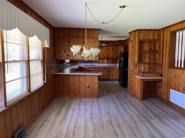 4155 Pinewood Dr, Mullins, SC 29574 - kitchen with kitchen peninsula, a chandelier, black fridge, and plenty of natural light