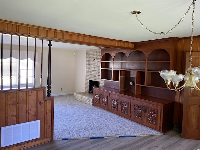4155 Pinewood Dr, Mullins, SC 29574 - living room featuring wood-type flooring, built in features, a fireplace, and an inviting chandelier