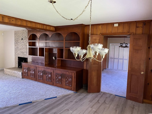 4155 Pinewood Dr, Mullins, SC 29574 - interior space with built in shelves, a brick fireplace, a notable chandelier, and hardwood / wood-style floors