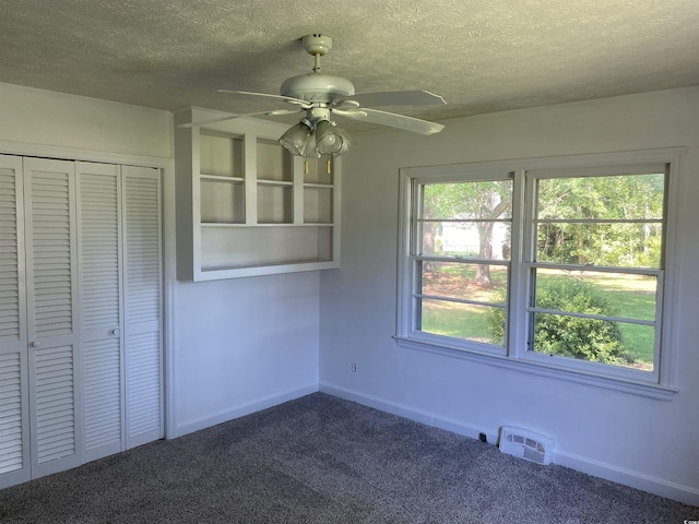4155 Pinewood Dr, Mullins, SC 29574 - interior space with ceiling fan, dark carpet, a textured ceiling, and a closet