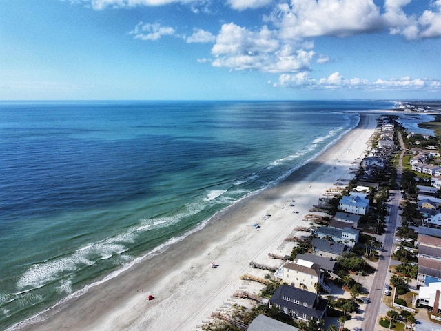 drone / aerial view with a beach view and a water view