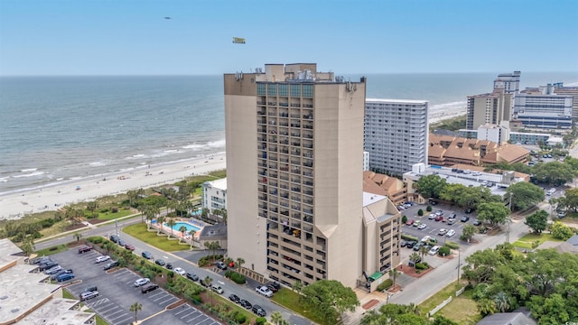 drone / aerial view featuring a water view and a beach view