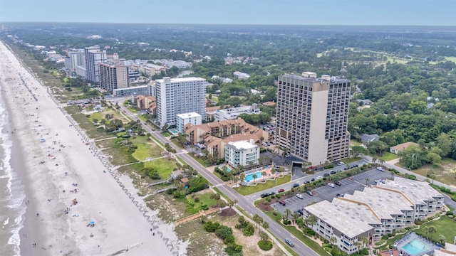 drone / aerial view featuring a water view and a beach view