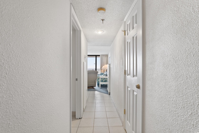 corridor featuring light tile patterned flooring