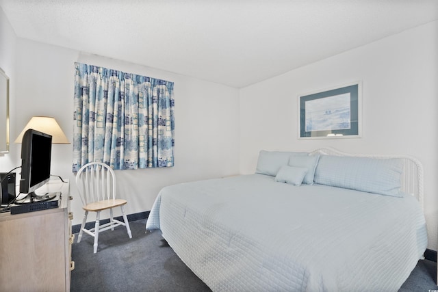 bedroom with dark colored carpet