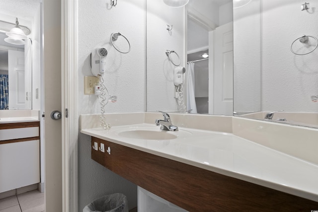 bathroom with tile patterned flooring and vanity