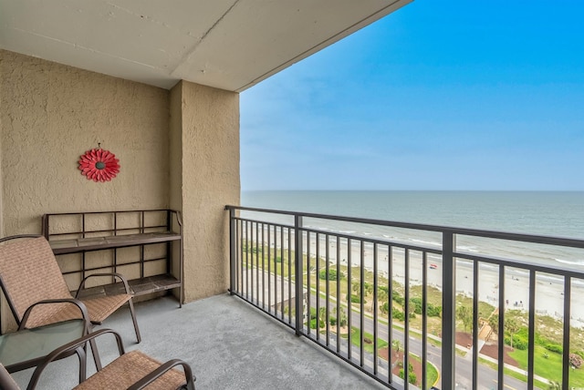 balcony featuring a water view and a view of the beach