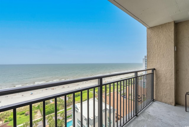 balcony with a water view and a beach view