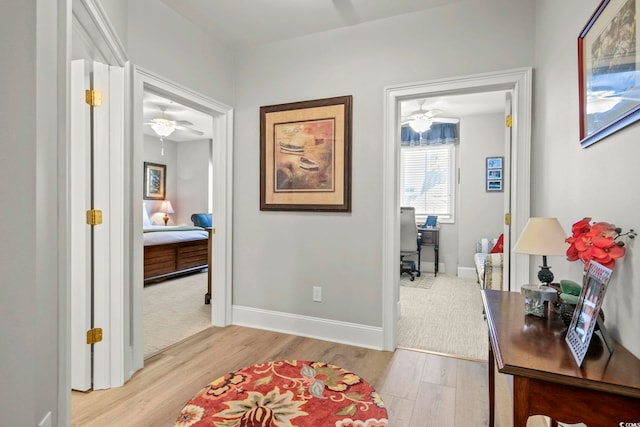 corridor with light hardwood / wood-style floors