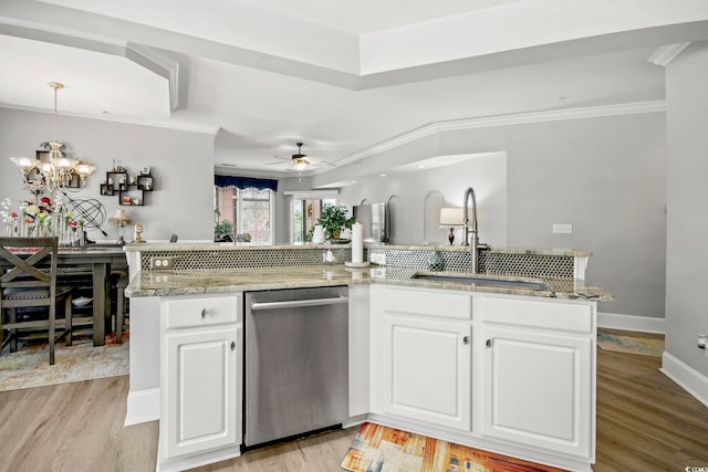 kitchen with sink, light hardwood / wood-style flooring, dishwasher, white cabinets, and decorative light fixtures