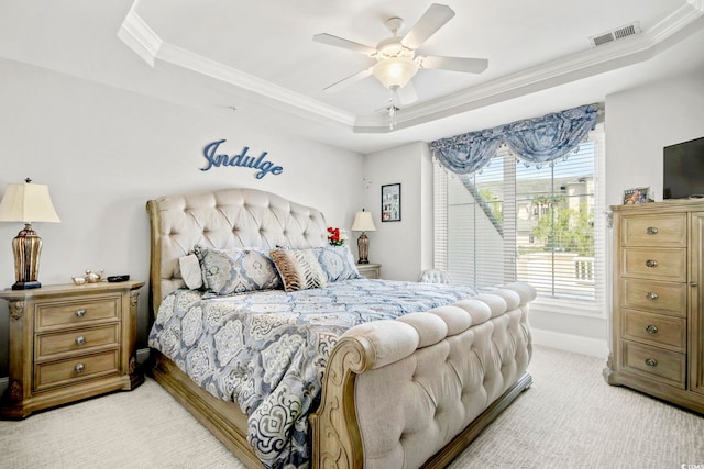 bedroom with light carpet, crown molding, a raised ceiling, and ceiling fan