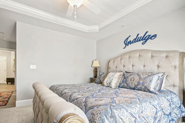 bedroom with a raised ceiling, ornamental molding, carpet flooring, and ceiling fan