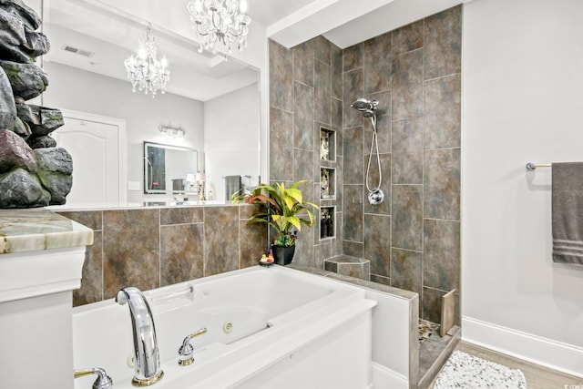 bathroom with wood-type flooring, shower with separate bathtub, and a chandelier