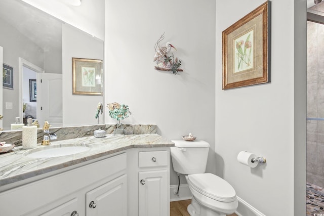 bathroom featuring vanity, toilet, and a shower