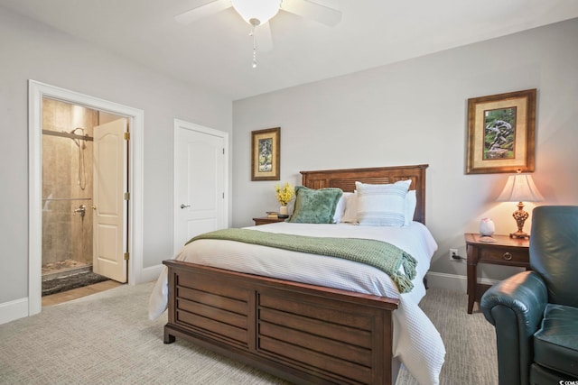 carpeted bedroom featuring ceiling fan and ensuite bathroom