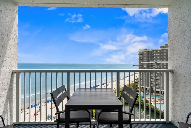 balcony with a beach view and a water view