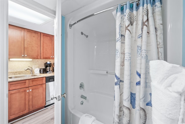 bathroom featuring decorative backsplash, shower / tub combo with curtain, wood finished floors, and vanity