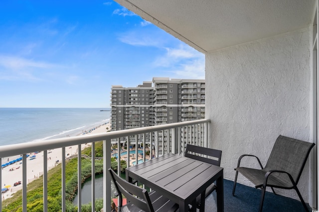 balcony with a beach view and a water view