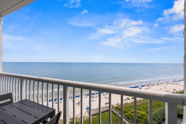 balcony with a water view and a beach view