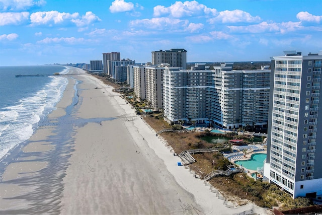 bird's eye view featuring a water view, a city view, and a beach view