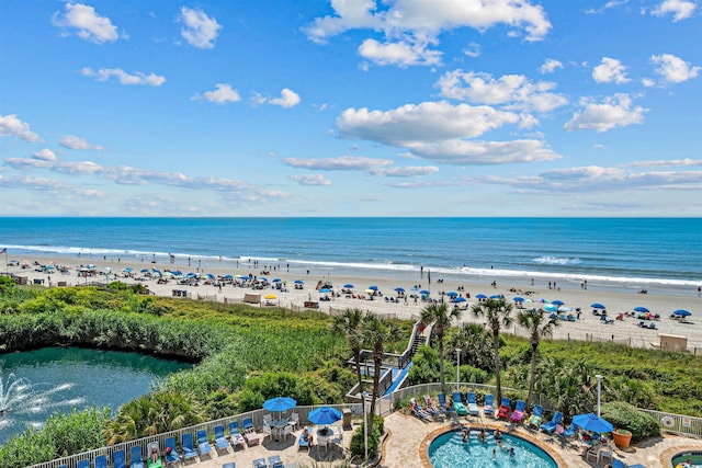 aerial view featuring a view of the beach and a water view