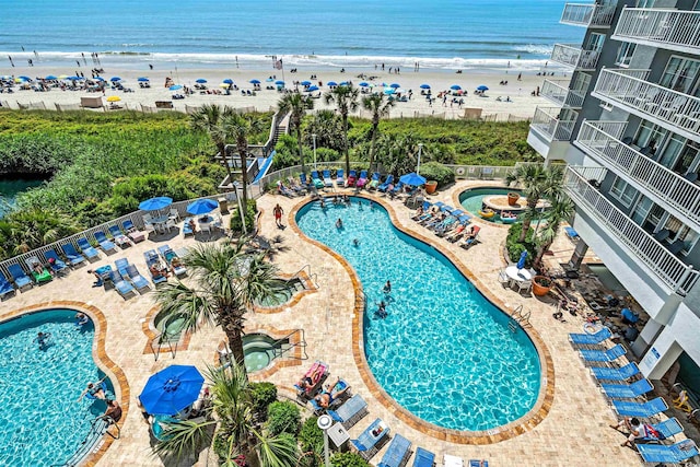 drone / aerial view with a water view and a view of the beach