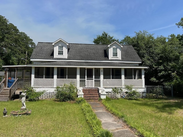 view of front of home featuring a sunroom and a front yard